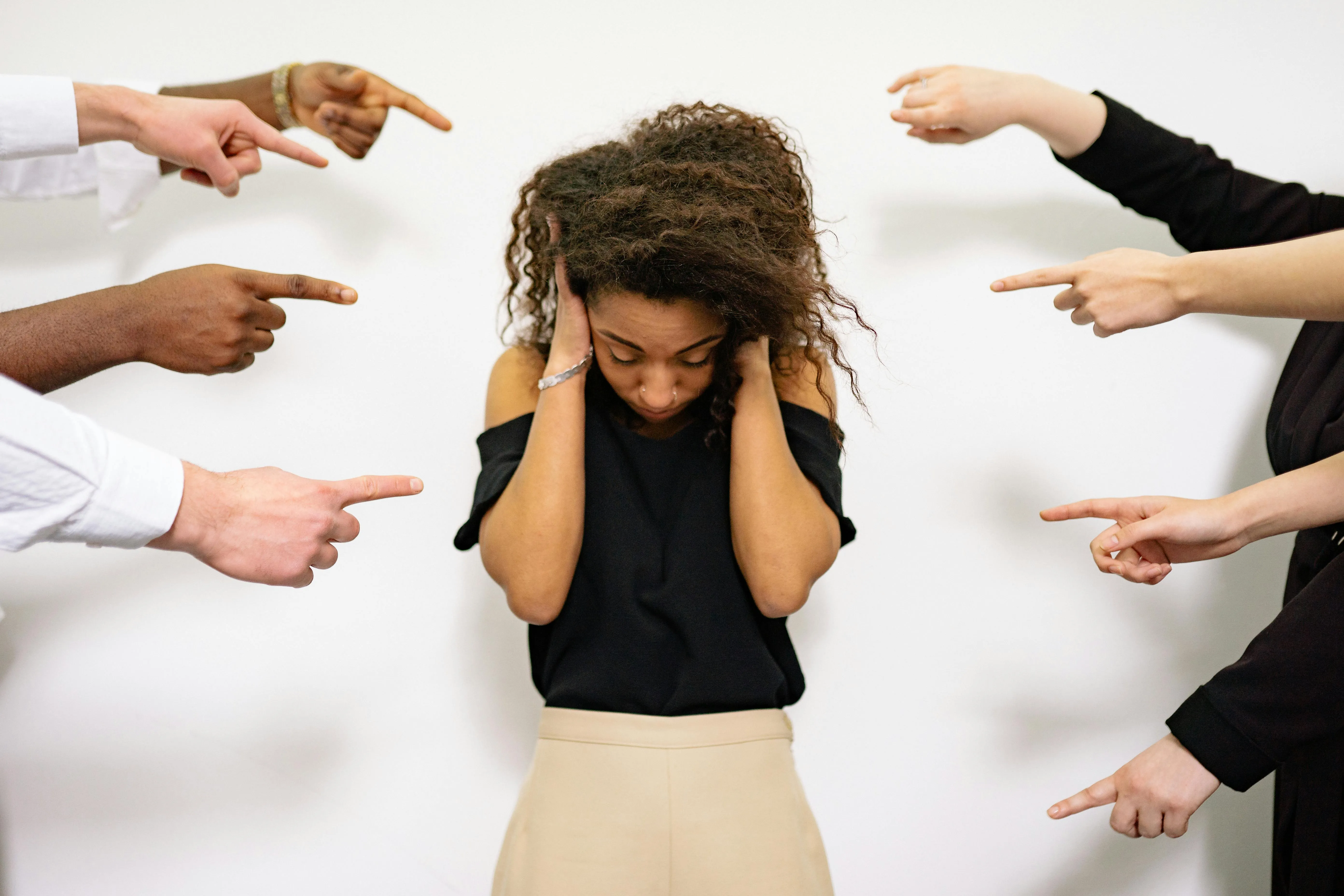 A woman looks down, visibly hurt and withdrawn
