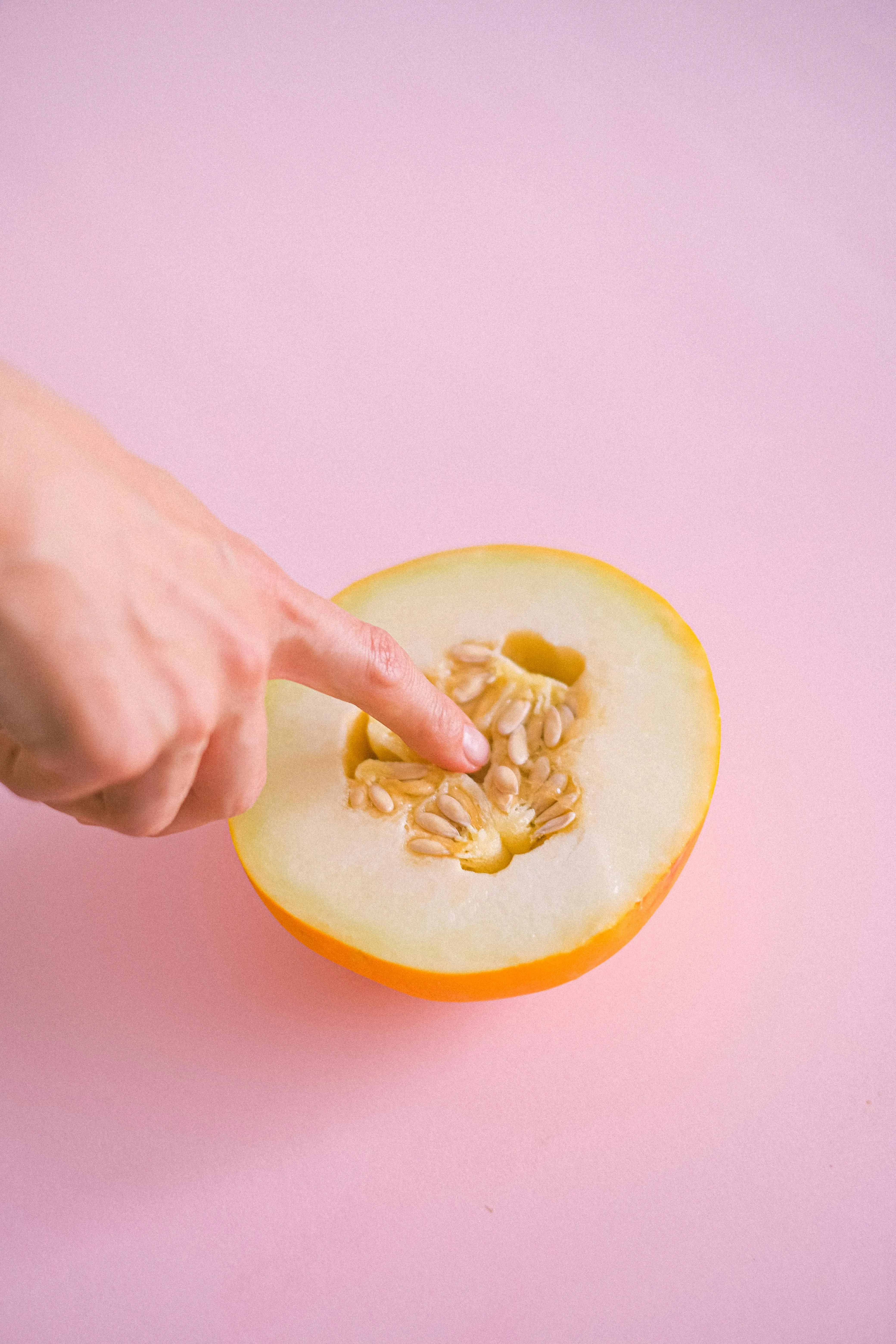A finger poking into exposed fruit