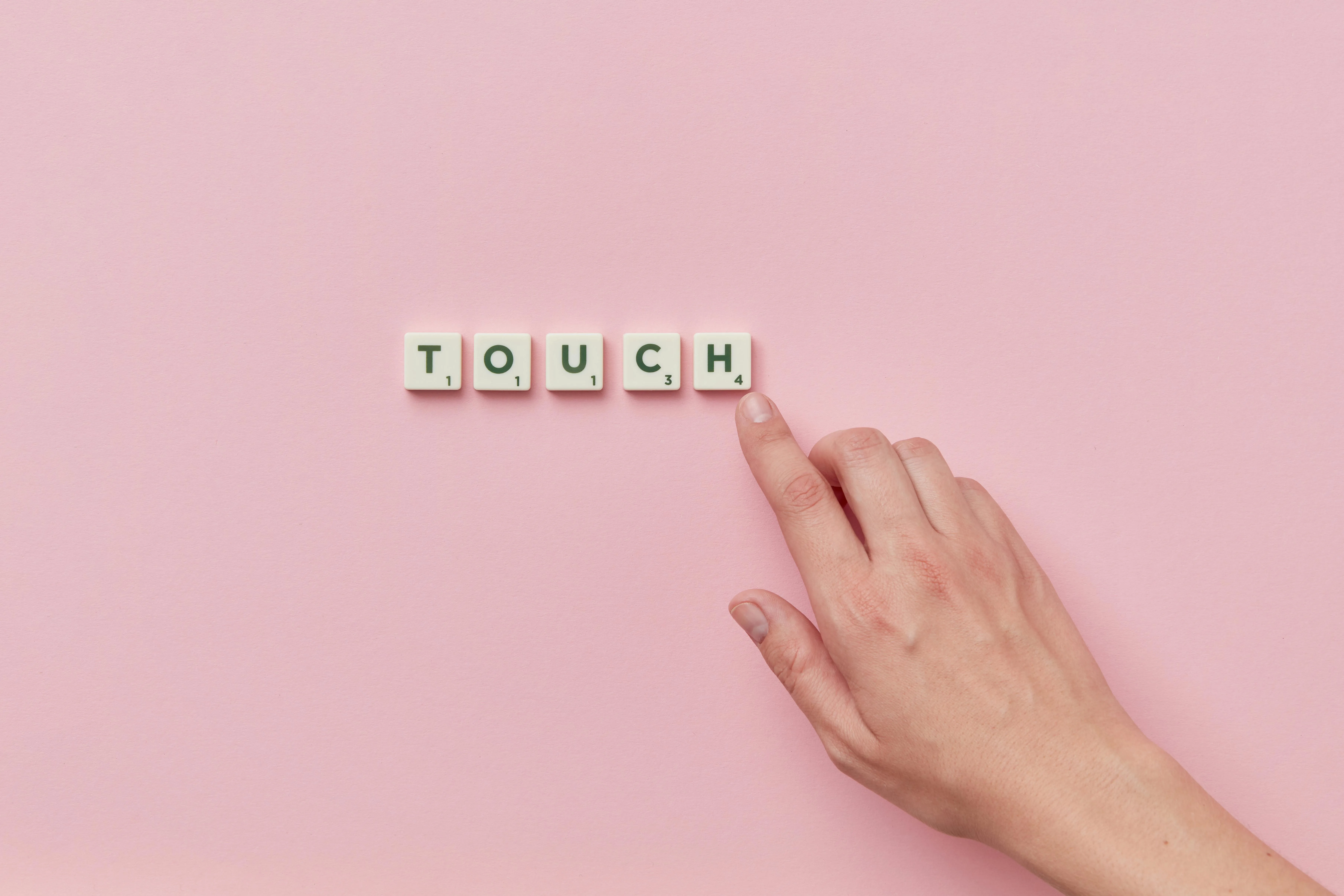 Scrabble tiles spelling out the word TOUCH