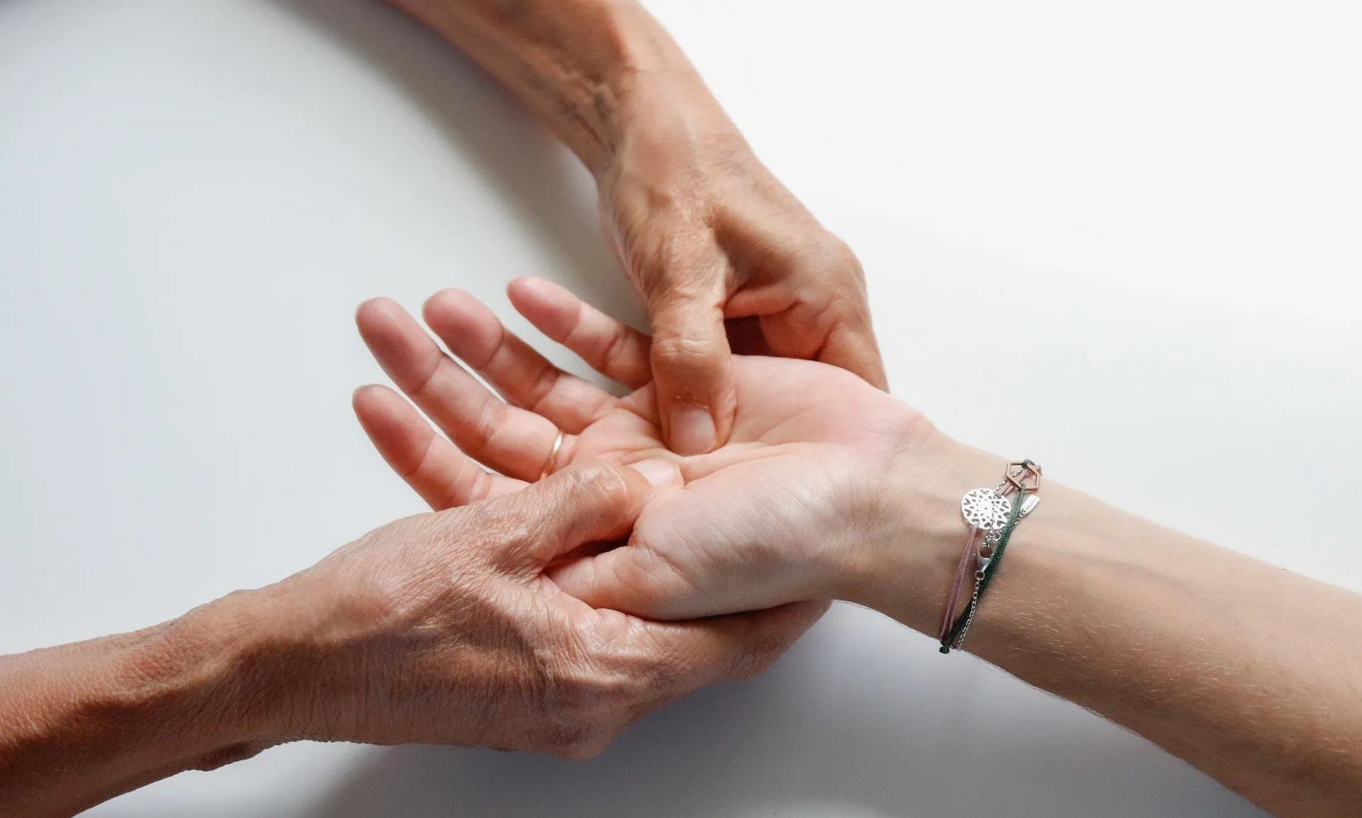 Two hands cradling another person's upturned palm